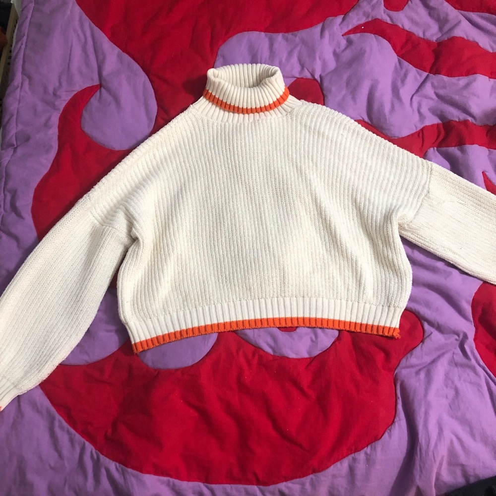 Cream roll neck sweater with adorable orange accents.